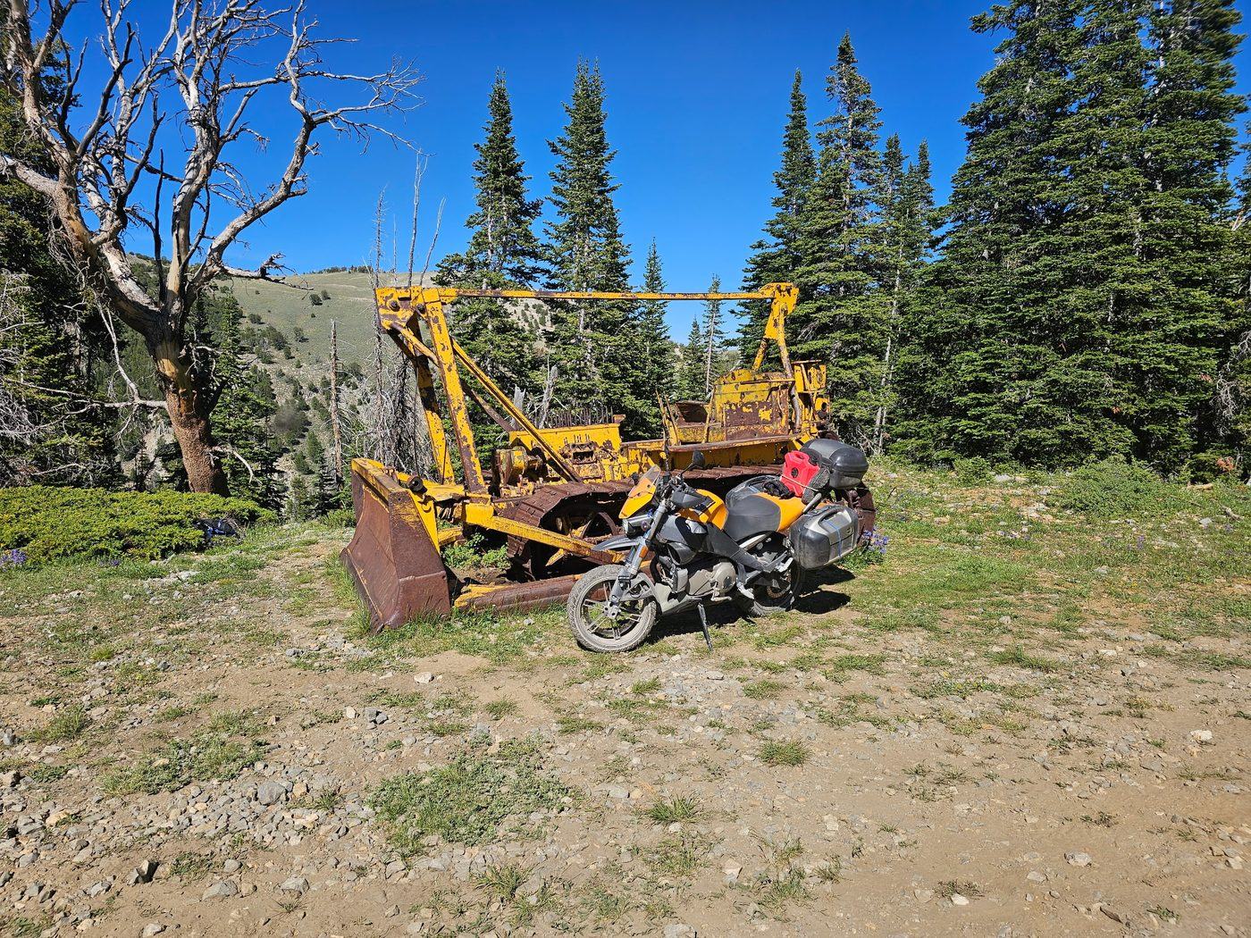 A 1940s dozer abandoned at 9,380 feet beside an adventure motorcycle high in the Idaho mountains